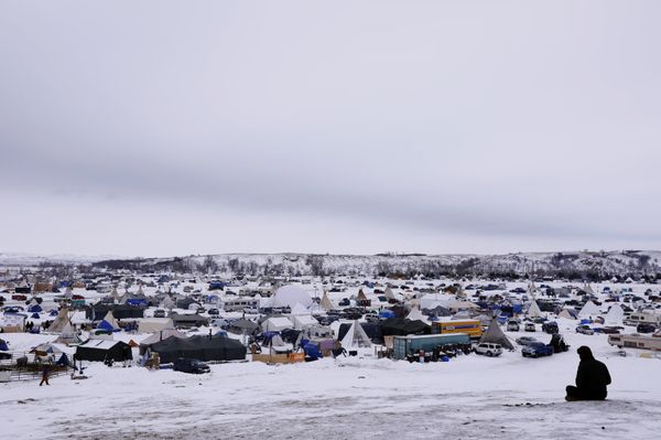 A man rests on top of a hill inside of the Oceti Sakowin camp as water protectors continue to demonstrate against plans to pass the Dakota Access pipeline near the Standing Rock Indian Reservation, near Cannon Ball, North Dakota, U.S., December 2, 2016 - Sputnik International