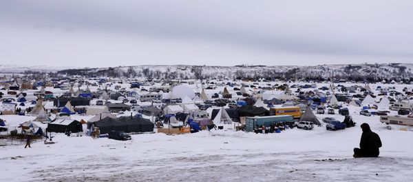 A man rests on top of a hill inside of the Oceti Sakowin camp as water protectors continue to demonstrate against plans to pass the Dakota Access pipeline near the Standing Rock Indian Reservation, near Cannon Ball, North Dakota, U.S., December 2, 2016 A man rests on top of a hill inside of the Oceti Sakowin camp as water protectors continue to demonstrate against plans to pass the Dakota Access pipeline near the Standing Rock Indian Reservation, near Cannon Ball, North Dakota, U.S., December 2, 2016 - Sputnik International