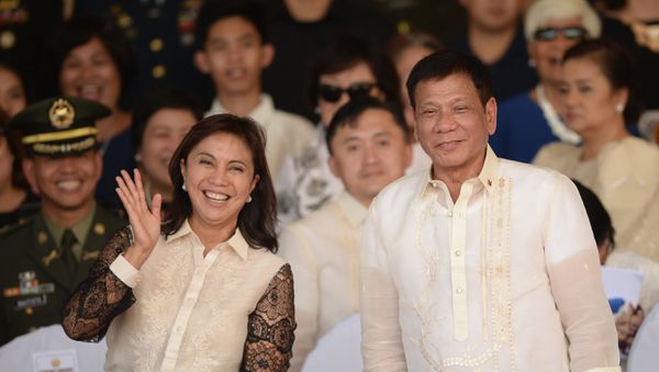 This file photo taken on July 1, 2016 shows Philippines' President Rodrigo Duterte (R) posing for photographs with Vice-President Leni Robredo after the military parade at the military headquarters in Manila - Sputnik International