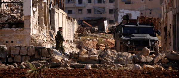 A Russian soldier walks to a military vehicle in goverment controlled Hanono housing district in Aleppo, Syria December 4, 2016 A Russian soldier walks to a military vehicle in goverment controlled Hanono housing district in Aleppo, Syria December 4, 2016 - Sputnik International