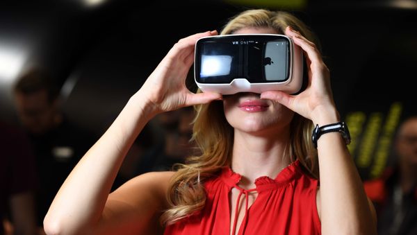A visitor tests virtual reality glasses at the Zeiss Optical stand at the Photokina trade fair in Cologne on September 20, 2016 A visitor tests virtual reality glasses at the Zeiss Optical stand at the Photokina trade fair in Cologne on September 20, 2016 - Sputnik International
