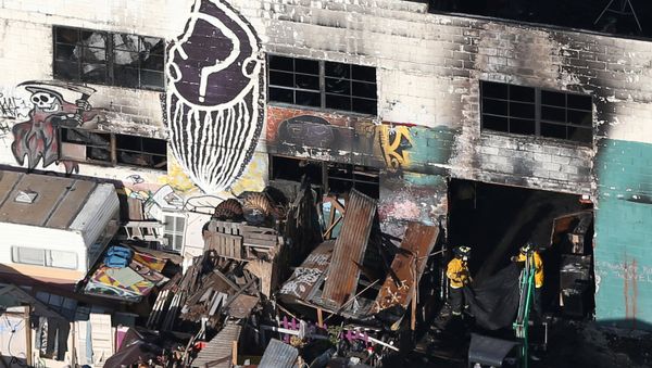 Firefighters work inside the burned warehouse following the fatal fire in the Fruitvale district of Oakland, California, U.S. December 4, 2016 - Sputnik International