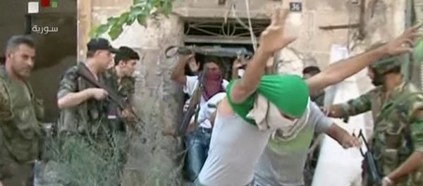 This still image from Syrian state TV video, shows young men with their faces covered surrendering to government forces, in Aleppo, Syria, Saturday, July 30, 2016 This still image from Syrian state TV video, shows young men with their faces covered surrendering to government forces, in Aleppo, Syria, Saturday, July 30, 2016 - Sputnik International