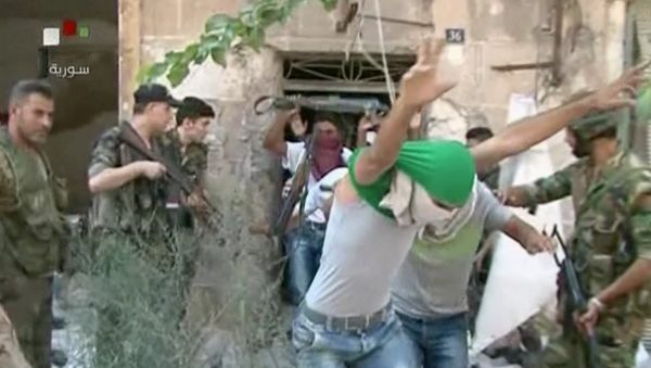 This still image from Syrian state TV video, shows young men with their faces covered surrendering to government forces, in Aleppo, Syria, Saturday, July 30, 2016 This still image from Syrian state TV video, shows young men with their faces covered surrendering to government forces, in Aleppo, Syria, Saturday, July 30, 2016 - Sputnik International