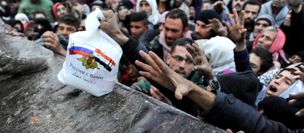 Syrians who have been evacuated from eastern Aleppo, reach out for Russian food aid in government-controlled Jibreen area in Aleppo, Syria November 30, 2016. The text on the bag, which shows the Syrian and Russian national flags, reads in Arabic: Russia is with you. Syrians who have been evacuated from eastern Aleppo, reach out for Russian food aid in government-controlled Jibreen area in Aleppo, Syria November 30, 2016. The text on the bag, which shows the Syrian and Russian national flags, reads in Arabic: Russia is with you. - Sputnik International