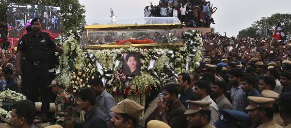 A glass casket carrying body of India's popular politician and former film actress Jayaram Jayalalithaa is taken in a funeral procession in Chennai, India, Tuesday, Dec. 6, 2016. Jayalalithaa, chief minister of Tamil Nadu state, died overnight following a heart attack a day earlier. A glass casket carrying body of India's popular politician and former film actress Jayaram Jayalalithaa is taken in a funeral procession in Chennai, India, Tuesday, Dec. 6, 2016. Jayalalithaa, chief minister of Tamil Nadu state, died overnight following a heart attack a day earlier. - Sputnik International