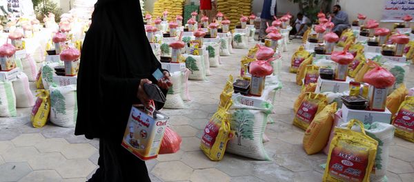 A Yemeni woman affected by the country's ongoing conflict walks past food rations provided by an initiative organised by a local charity in the capital Sanaa on June 2, 2016. A Yemeni woman affected by the country's ongoing conflict walks past food rations provided by an initiative organised by a local charity in the capital Sanaa on June 2, 2016. - Sputnik International