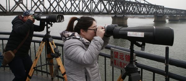 Chinese tourists watch the North Korean side across the Yalu River using telescopes in Dandong, Northeast China's Liaoning Province Chinese tourists watch the North Korean side across the Yalu River using telescopes in Dandong, Northeast China's Liaoning Province - Sputnik International