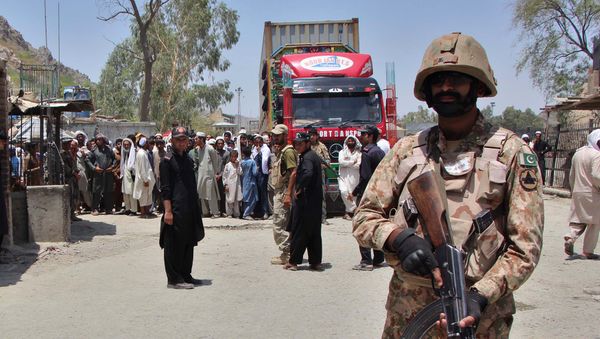 A Pakistani soldier stands guard as a truck enters Pakistan from Afghanistan at the border crossing in Torkham A Pakistani soldier stands guard as a truck enters Pakistan from Afghanistan at the border crossing in Torkham - Sputnik International