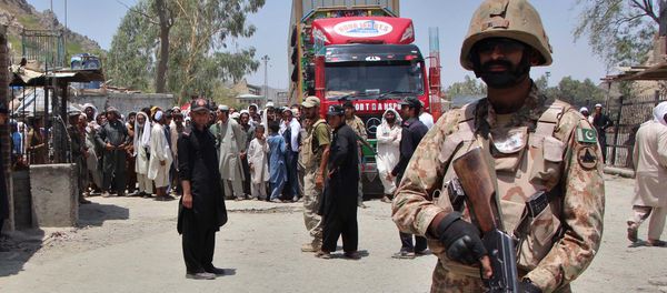 A Pakistani soldier stands guard as a truck enters Pakistan from Afghanistan at the border crossing in Torkham A Pakistani soldier stands guard as a truck enters Pakistan from Afghanistan at the border crossing in Torkham - Sputnik International