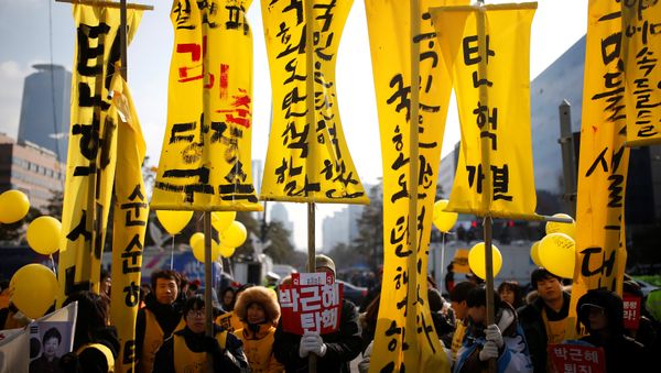Protesters attend a rally demanding the impeachment of South Korean President Park Geun-hye in front of the National Assembly in Seoul, South Korea, December 9, 2016. The sign reads Impeach Park Geun-hye. Protesters attend a rally demanding the impeachment of South Korean President Park Geun-hye in front of the National Assembly in Seoul, South Korea, December 9, 2016. The sign reads Impeach Park Geun-hye. - Sputnik International