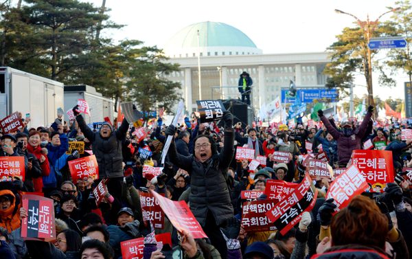 People react after impeachment vote on South Korean President Park Geun-hye was passed, in front of the National Assembly in Seoul, South Korea, December 9, 2016. The sign reads Impeach Park Geun-hye. People react after impeachment vote on South Korean President Park Geun-hye was passed, in front of the National Assembly in Seoul, South Korea, December 9, 2016. The sign reads Impeach Park Geun-hye. - Sputnik International
