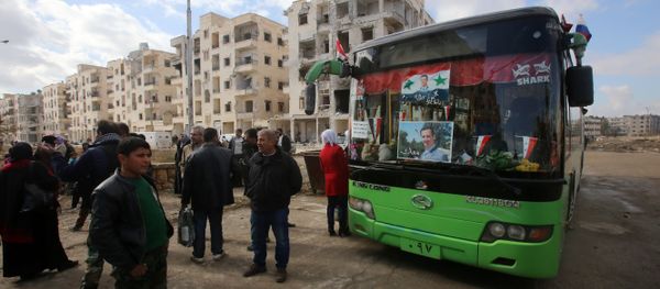 Syrians, from various western districts, wait at the Razi bus stop in Aleppo's central Jamiliyeh neighbourhood before taking part in a bus trip through government-held territory between the two sides of the divided city on December 3, 2016 as the pro-government forces seized 60 percent of the former rebel stronghold in east Aleppo - Sputnik International