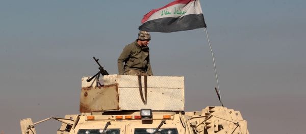 An Iraqi soldier stands atop an armoured vehicle in the town of Tal Abtah, south of Tal Afar, on December 10, 2016, after they retook the area during a broad offencive to retake the city of Mosul from Islamic State (IS) jihadists - Sputnik International