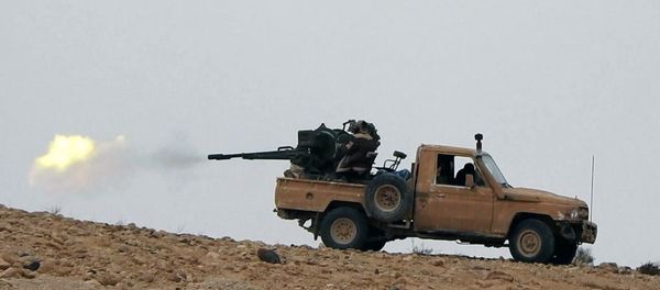 This image posted online on Saturday, Dec. 10, 2016, by supporters of the Islamic State militant group on an anonymous photo sharing website, purports to show a gun-mounted vehicle operated by the group firing at Syrian troops north of Palmyra city, in Homs, Syria - Sputnik International