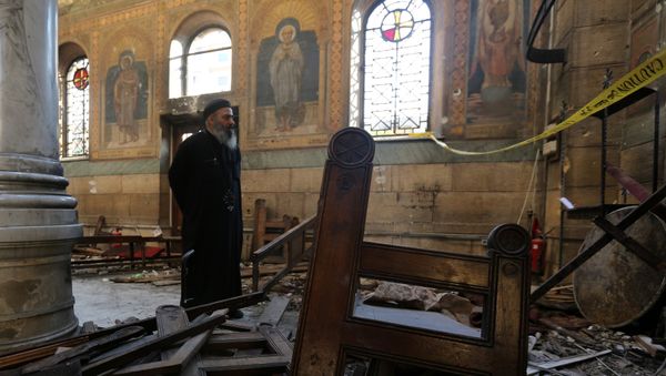 A Coptic priest stands at the scene following a bombing inside Cairo's Coptic cathedral in Egypt December 11, 2016 - Sputnik International