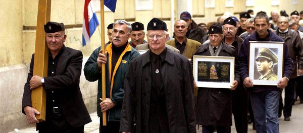 A group of mostly older Croatians, wearing Second World War Ustasha regime uniforms, parade in the Croatian Adriatic resort of Zadar, carrying a portrait of the late Ustasha leader, Ante Pavelic (R), 07 December 2004 - Sputnik International