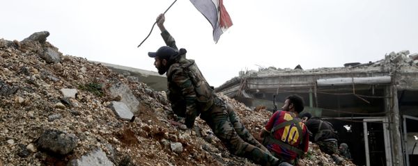 Syrian army soldier places a Syrian national flag during a battle with rebel fighters at the Ramouseh front line, east of Aleppo, Syria Syrian army soldier places a Syrian national flag during a battle with rebel fighters at the Ramouseh front line, east of Aleppo, Syria - Sputnik International