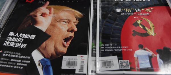 A magazine featuring US President-elect Donald Trump is seen at a bookstore in Beijing on December 12, 2016. The headline reads How will businessman Trump change the world - Sputnik International