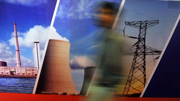 A delegate of the India Nuclear Energy 2011 summit walks past a stall in Mumbai on September 29, 2011 - Sputnik International