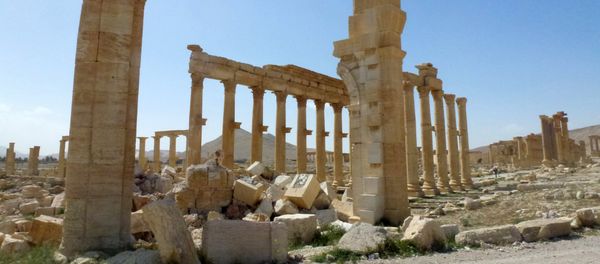 This file photo taken on March 27, 2016 shows a view of the remains of Arch of Triumph, also called the Monumental Arch of Palmyra, that was destroyed by Islamic State (IS) group jihadists in October 2015 in the ancient Syrian city of Palmyra - Sputnik International