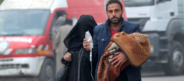 A man carries a child with an IV drip as he flees deeper into the remaining rebel-held areas of Aleppo, Syria December 12, 2016 - Sputnik International
