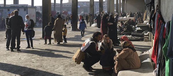 This image released by the International Committee for the Red Cross (ICRC) shows Syrians who were displaced with their families from eastern Aleppo gather at the collective shelter, in the village of Jibreen south of Aleppo, Syria, Monday, Dec. 12, 2016 This image released by the International Committee for the Red Cross (ICRC) shows Syrians who were displaced with their families from eastern Aleppo gather at the collective shelter, in the village of Jibreen south of Aleppo, Syria, Monday, Dec. 12, 2016 - Sputnik International