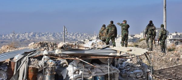 Syrian pro-government forces patrol Aleppo's Sheikh Saeed district, on December 12, 2016, after troops retook the area from rebel fighters - Sputnik International