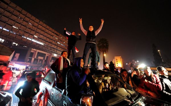 Supporters of Syria's President Bashar al-Assad carry their national flags and gesture as they tour the streets in celebration of what they say is the Syrian army's victory against the rebels in Aleppo, Syria December 12, 2016 - Sputnik International