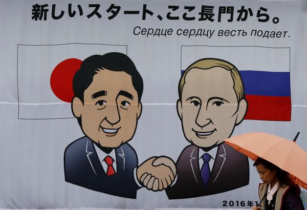 A woman walks past a banner showing Japan's Prime Minister Shinzo Abe and Russian President Vladimir Putin at the Senzaki station in Nagato, Yamaguchi prefecture, Japan, December 14, 2016 A woman walks past a banner showing Japan's Prime Minister Shinzo Abe and Russian President Vladimir Putin at the Senzaki station in Nagato, Yamaguchi prefecture, Japan, December 14, 2016 - Sputnik International
