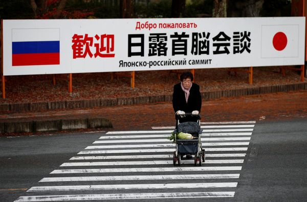 A woman walks in front of a sign board that reads Welcome Japan Russia summit meeting near a hot spring resort, the venue of the summit meeting between Japanese Prime Minister Shinzo Abe and Russian President Vladimir Putin, in Nagato, Yamaguchi prefecture, Japan, December 15, 2016. A woman walks in front of a sign board that reads Welcome Japan Russia summit meeting near a hot spring resort, the venue of the summit meeting between Japanese Prime Minister Shinzo Abe and Russian President Vladimir Putin, in Nagato, Yamaguchi prefecture, Japan, December 15, 2016. - Sputnik International