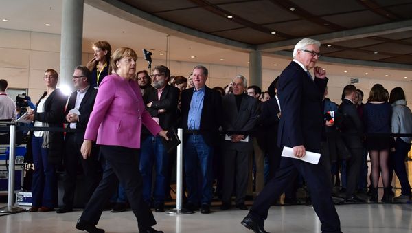 German Chancellor Angela Merkel (R) and Frank-Walter Steinmeier leave after a press conference together with the presidents of the ruling coalition Sigmar Gabriel (SPD)(Unseen) and Horst Seehofer (CSU)(Unseen) to present Frank-Walter Steinmeier as their candidate for German president on November 16, 2016 at the German lower house of parliament (the Bundestag) in Berlin. - Sputnik International