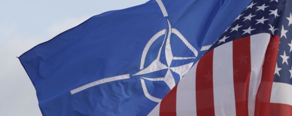 NATO and US flags wave in the wind outside NATO headquarters in Brussels. (File) - Sputnik International