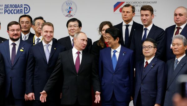 Russian President Vladimir Putin (3rd L) and Japanese Prime minister Shinzo Abe (3rd R) attend a Japanese-Russian business dialogue meeting in Tokyo, Japan, December 16, 2016. Russian President Vladimir Putin (3rd L) and Japanese Prime minister Shinzo Abe (3rd R) attend a Japanese-Russian business dialogue meeting in Tokyo, Japan, December 16, 2016. - Sputnik International