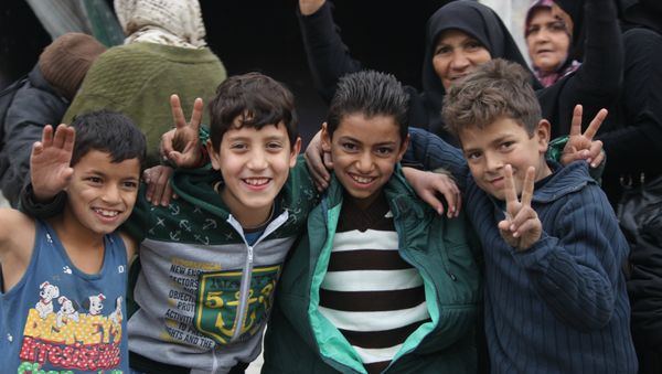 Children celebrating liberation in Hanano, East Aleppo Children celebrating liberation in Hanano, East Aleppo - Sputnik International