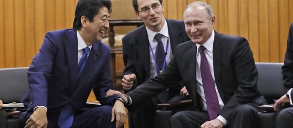 Russian President Vladimir Putin and Japanese Prime Minister Shinzo Abe share a light moment during their visit at Kodokan judo hall in Tokyo, Japan, December 16, 2016. Russian President Vladimir Putin and Japanese Prime Minister Shinzo Abe share a light moment during their visit at Kodokan judo hall in Tokyo, Japan, December 16, 2016. - Sputnik International