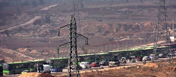 Buses are seen during an evacuation operation of Syrian rebel fighters and civilians from a opposition-held area of Aleppo towards rebel-held territory in the west of Aleppo's province - Sputnik International