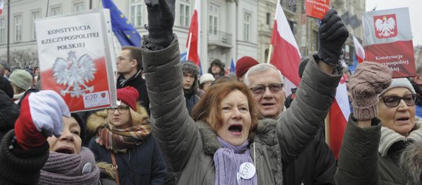 Protesters holding copies of Poland's constitution shout slogans during an anti-government demonstration, in Warsaw, Poland Protesters holding copies of Poland's constitution shout slogans during an anti-government demonstration, in Warsaw, Poland - Sputnik International
