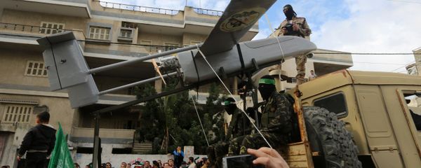 Palestinian militants of the Ezzedine al-Qassam Brigades, Hamas' armed wing, dislpay a drone during a parade marking the 27th anniversary of the Islamist movement’s creation on December 14, 2014 in Gaza City - Sputnik International