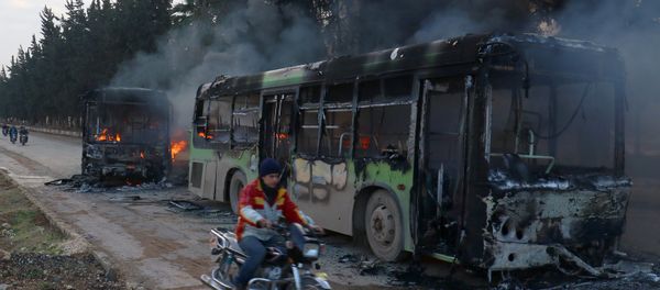 A man on a motorcycle drives past burning buses while en route to evacuate ill and injured people from the besieged Syrian villages of al-Foua and Kefraya, after they were attacked and burned, in Idlib province, Syria December 18, 2016 A man on a motorcycle drives past burning buses while en route to evacuate ill and injured people from the besieged Syrian villages of al-Foua and Kefraya, after they were attacked and burned, in Idlib province, Syria December 18, 2016 - Sputnik International