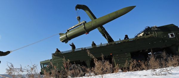 Russian soldiers watch a transporter-loader place an Iskander-M shorter-range missile onto a launcher during an exercise Russian soldiers watch a transporter-loader place an Iskander-M shorter-range missile onto a launcher during an exercise - Sputnik International