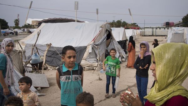 Refugees stand at a camp in Latakia, Syria Refugees stand at a camp in Latakia, Syria - Sputnik International