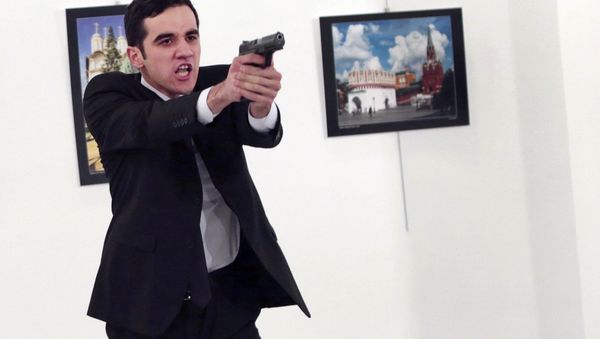 Gunman gestures after shooting the Russian Ambassador to Turkey, Andrei Karlov, at a photo gallery in Ankara, Turkey, Monday, Dec. 19, 2016 - Sputnik International