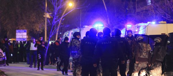 Turkish police officers secure the area close to a photo gallery where the Russian Ambassador to Turkey, Andrei Karlov, was shot by a gunman in Ankara, Turkey. - Sputnik International