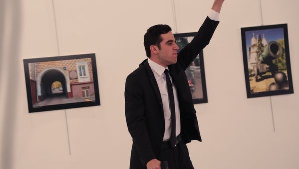An unnamed gunman gestures after shooting the Russian Ambassador to Turkey, Andrei Karlov, at a photo gallery in Ankara. - Sputnik International
