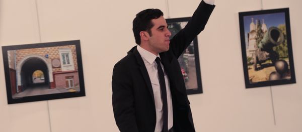 An unnamed gunman gestures after shooting the Russian Ambassador to Turkey, Andrei Karlov, at a photo gallery in Ankara. - Sputnik International