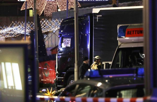 Police stand beside a damaged truck which ran into crowded Christmas market in Berlin, Germany. - Sputnik International