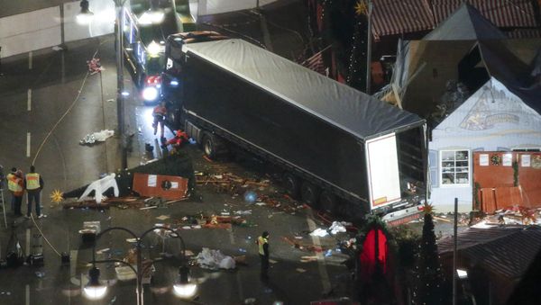 A used suit of a forensic investigator lies on a Christmas tree where a truck ploughed through a crowded Christmas market killing 12 people in the west of Berlin, Germany, December 20, 2016 - Sputnik International