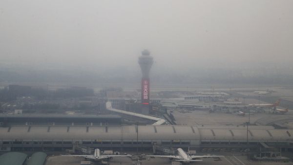 Passenger planes are on the tarmac at the Beijing Capital International Airport shrouded by pollution haze in Beijing, Thursday, Nov. 17, 2016 Passenger planes are on the tarmac at the Beijing Capital International Airport shrouded by pollution haze in Beijing, Thursday, Nov. 17, 2016 - Sputnik International