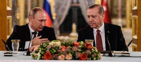 (FILES) This file photo taken on October 10, 2016 shows Russian President Vladimir Putin (L) speaking to Turkish President Recep Tayyip Erdogan (R) as they attend a press conference in Istanbul - Sputnik International
